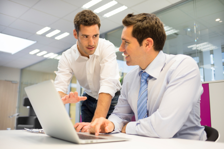 two men learning in a business setting.