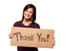 woman holding sign saying Thank You Donors