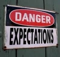 picture of a sign saying danger expectations expect