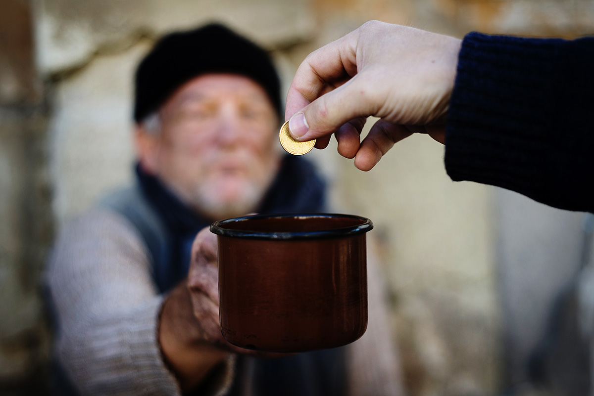 Man holding over cup.