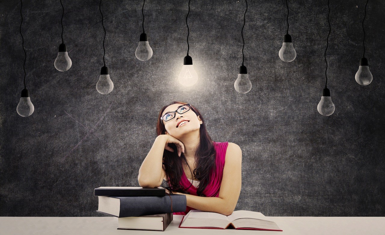 Woman with light bulb overhead.