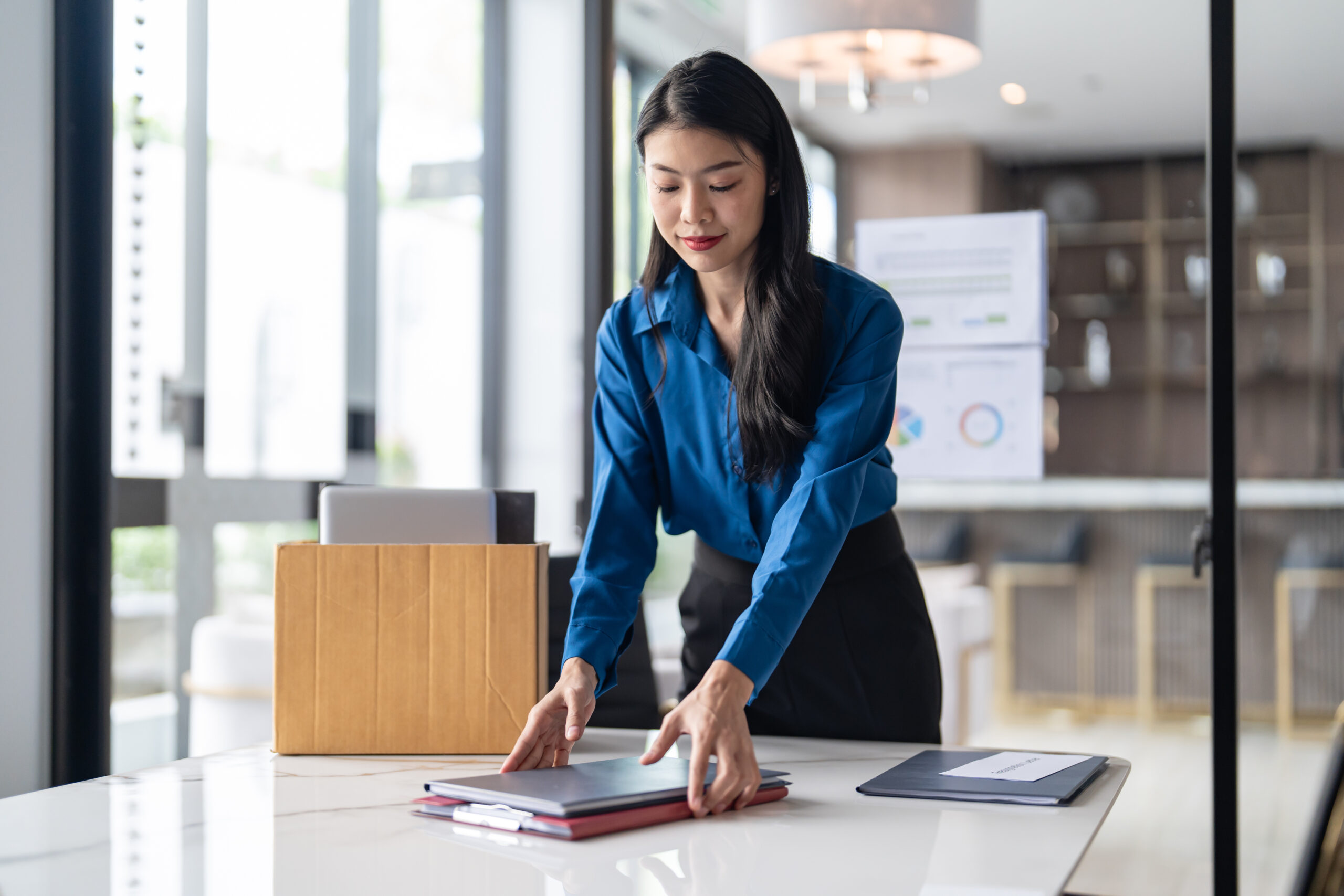 Business woman organizing files to leave her job. [How to Love Your Donors After You Leave]