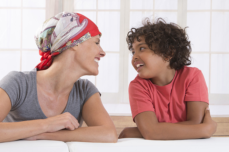 Cancer survivor with smiling child.