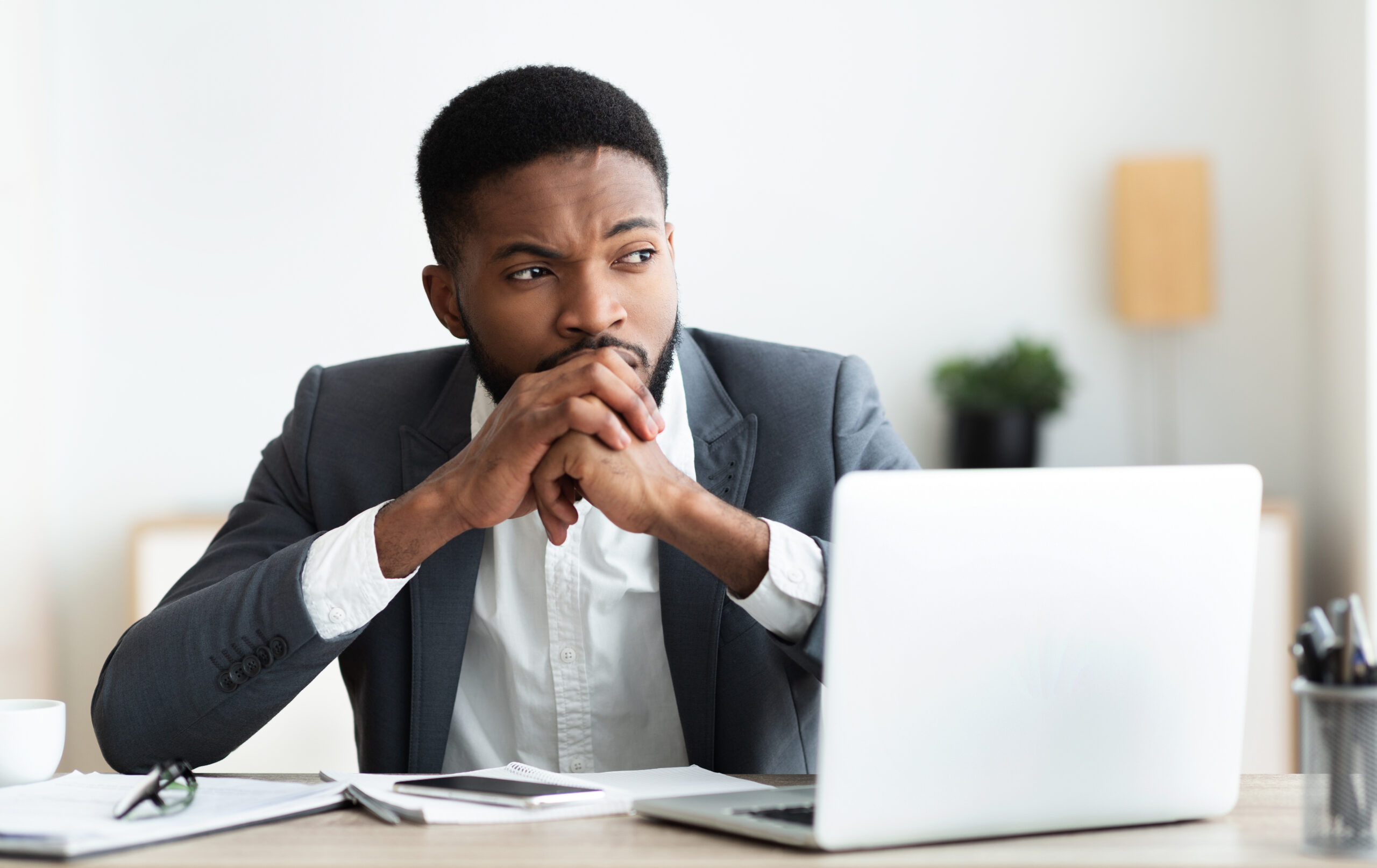 Fundraiser sitting at computer, contemplating how to make organizational change. [If You Feel Powerless, How Do You Advocate for Change to Happen?]