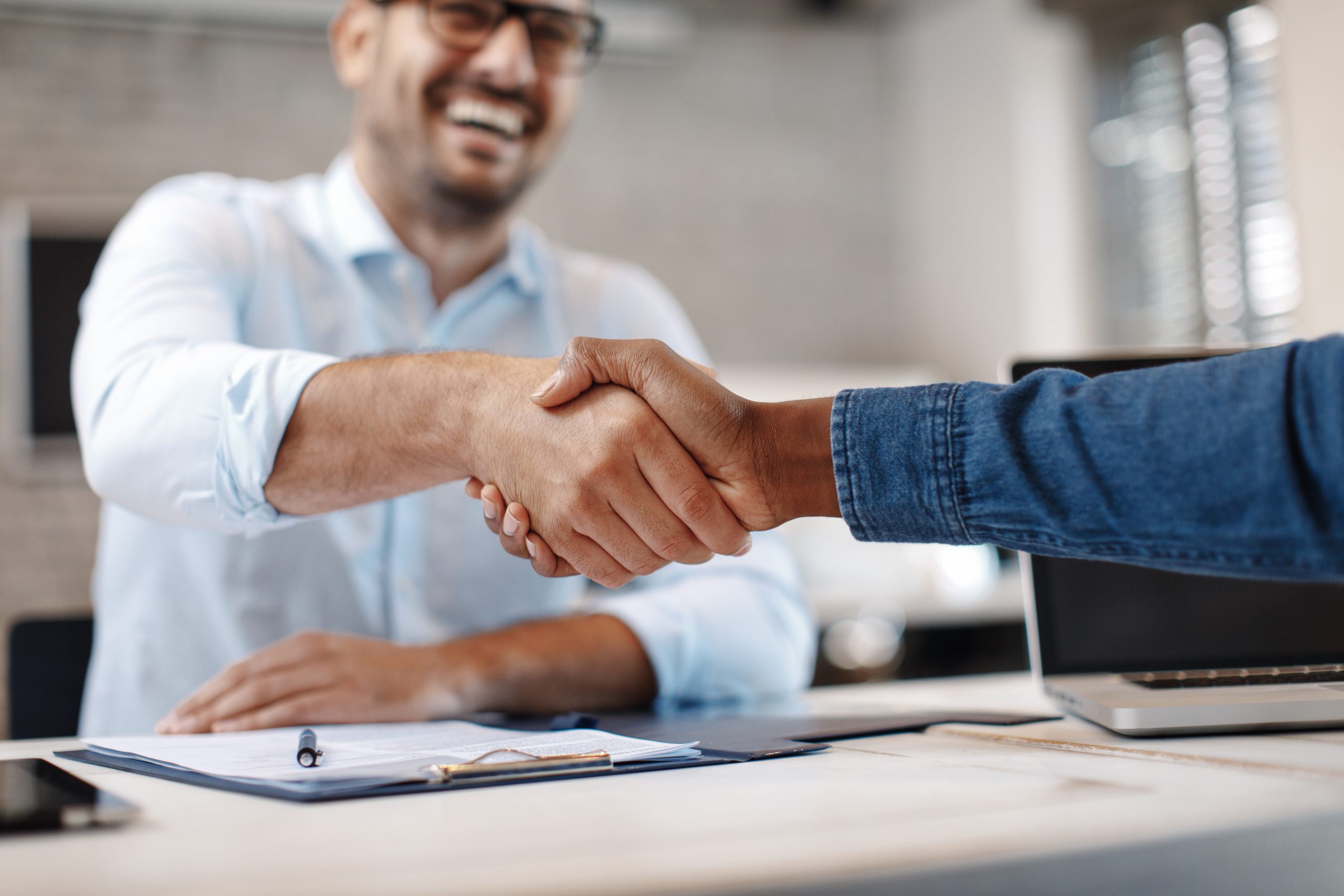 A fundraiser shakes hands with a donor.