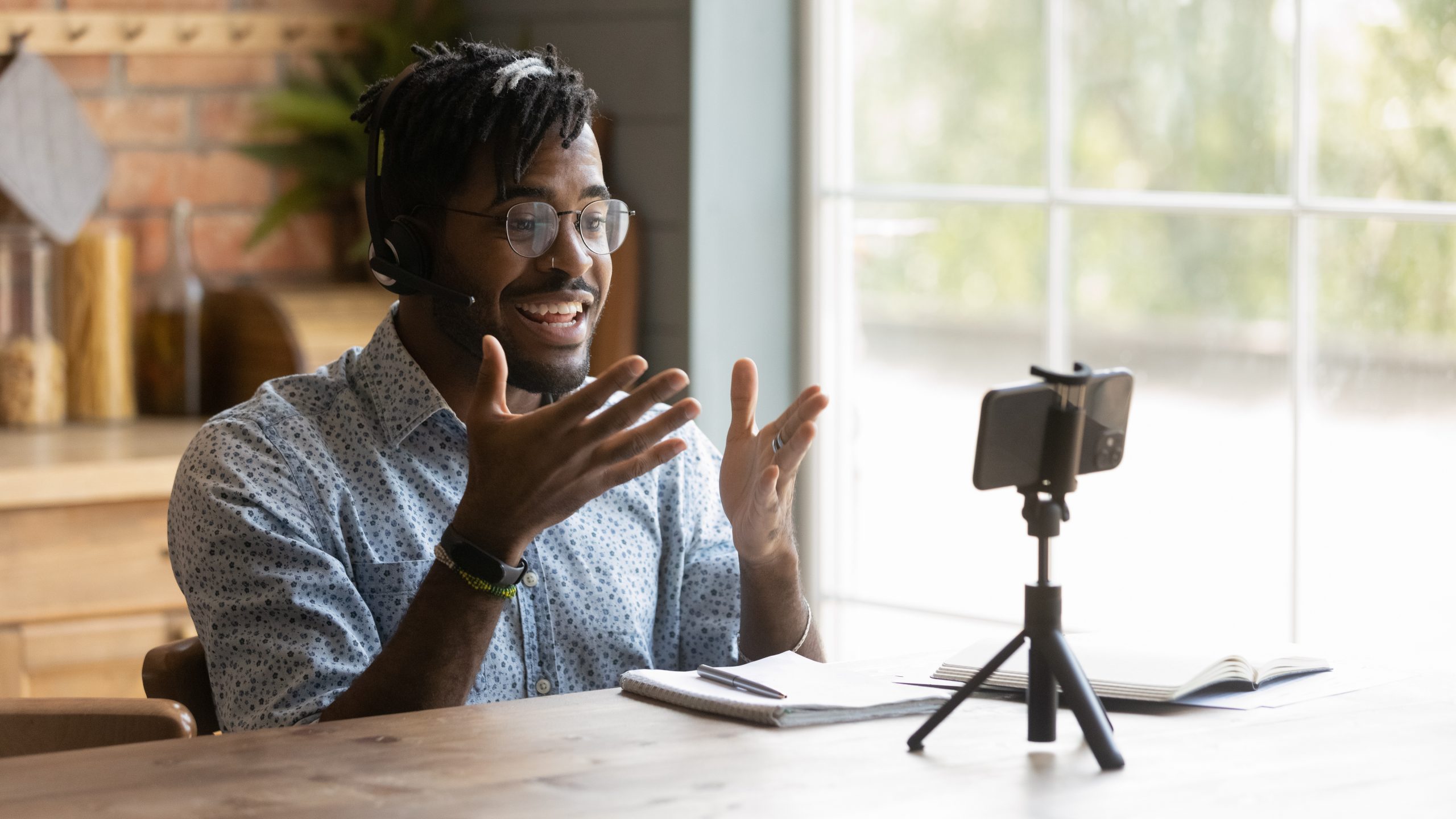 A fundraiser records himself on his phone to create video touch points for donor outreach.