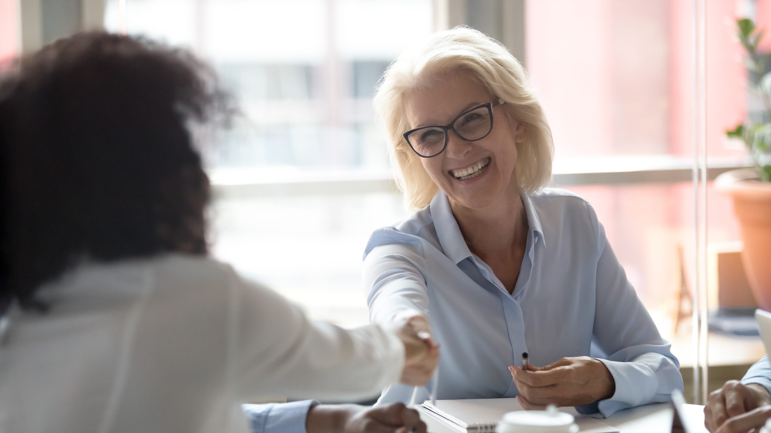 A fundraiser shaking hands with a donor. How to Have Better Donor Conversations Through Ritual