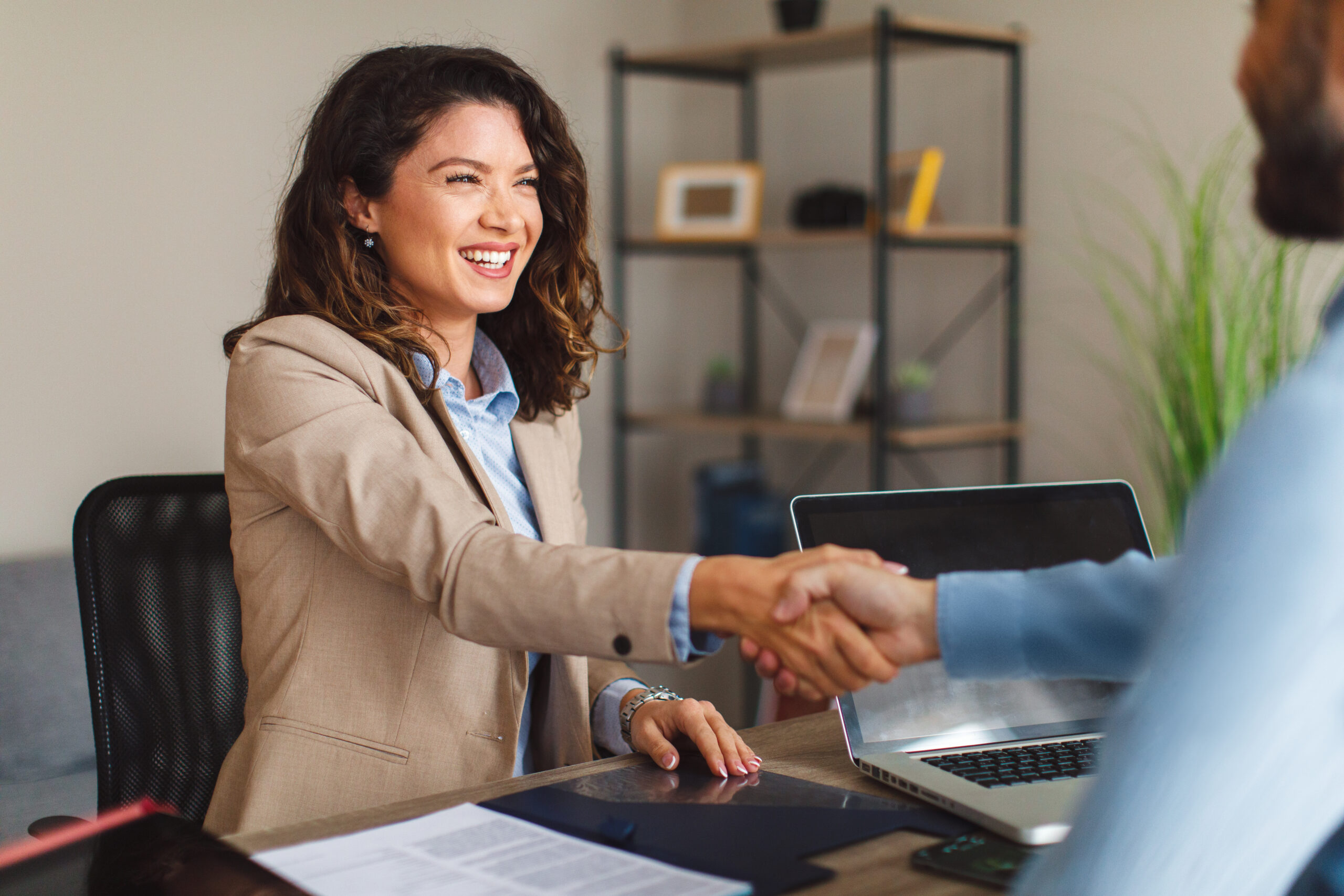 A fundraiser shaking hands with a donor and working to build relationships.