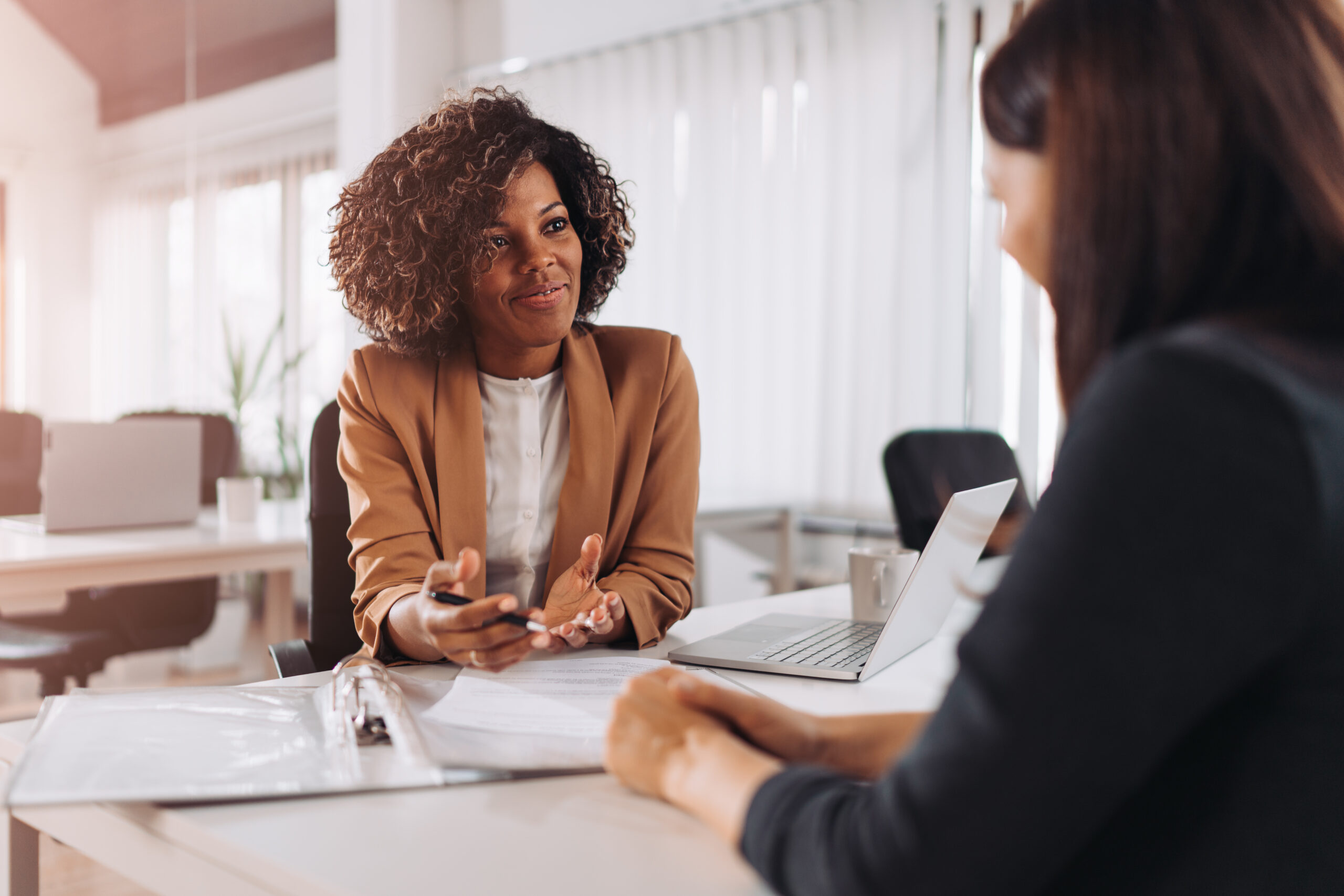 Businesswoman asking another woman a question about open mindsets. [Ask Your Donors for Gifts That Are Soul Filling]