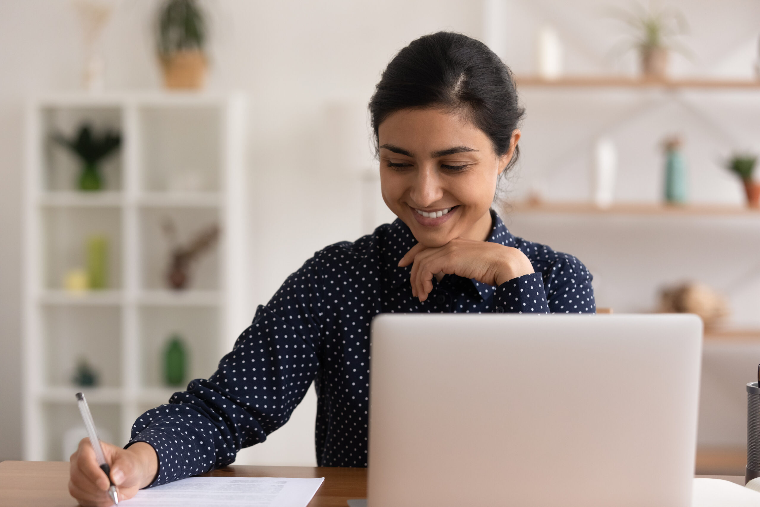 Indian businesswoman taking notes during online meeting. [A Major Donor's Perspective on What Makes a Great Meeting]