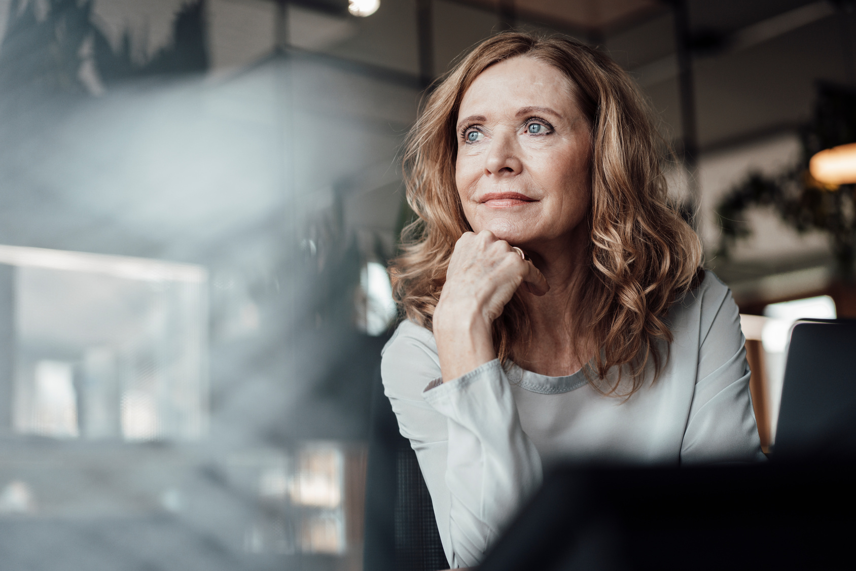 Thoughtful businesswoman with hand on chin at office [There’s a Certain Sacredness to Managing People]