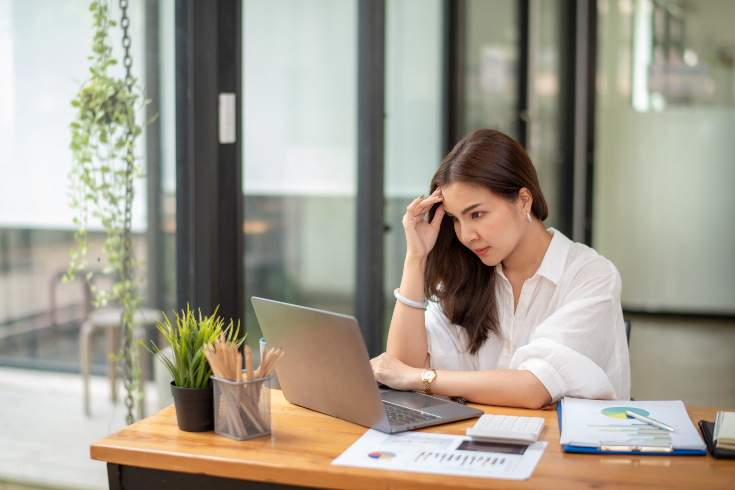 Business woman sitting at work feeling stressed [Why Talking About the Problem Is So Difficult]