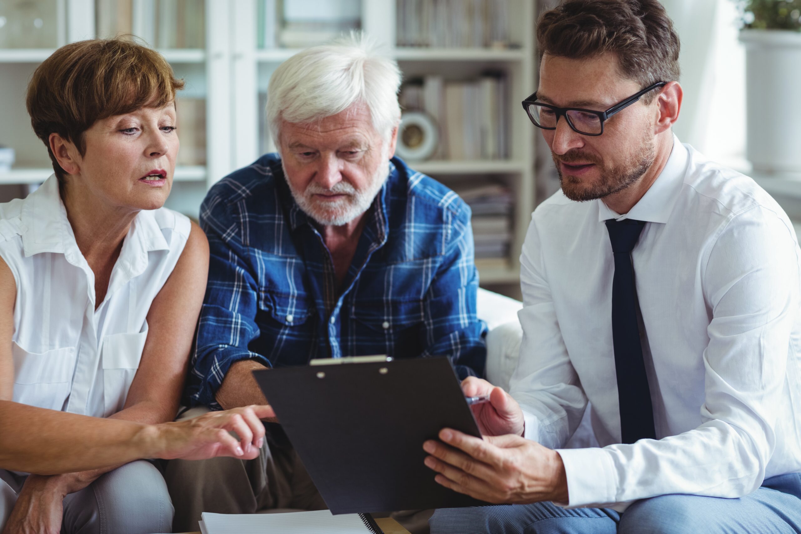 Financial advisor speaks to couple about tax code change. [Estate Planning, Tax Code, and Planned Giving – Are You Prepared for Upcoming Changes That Could Impact Giving?]