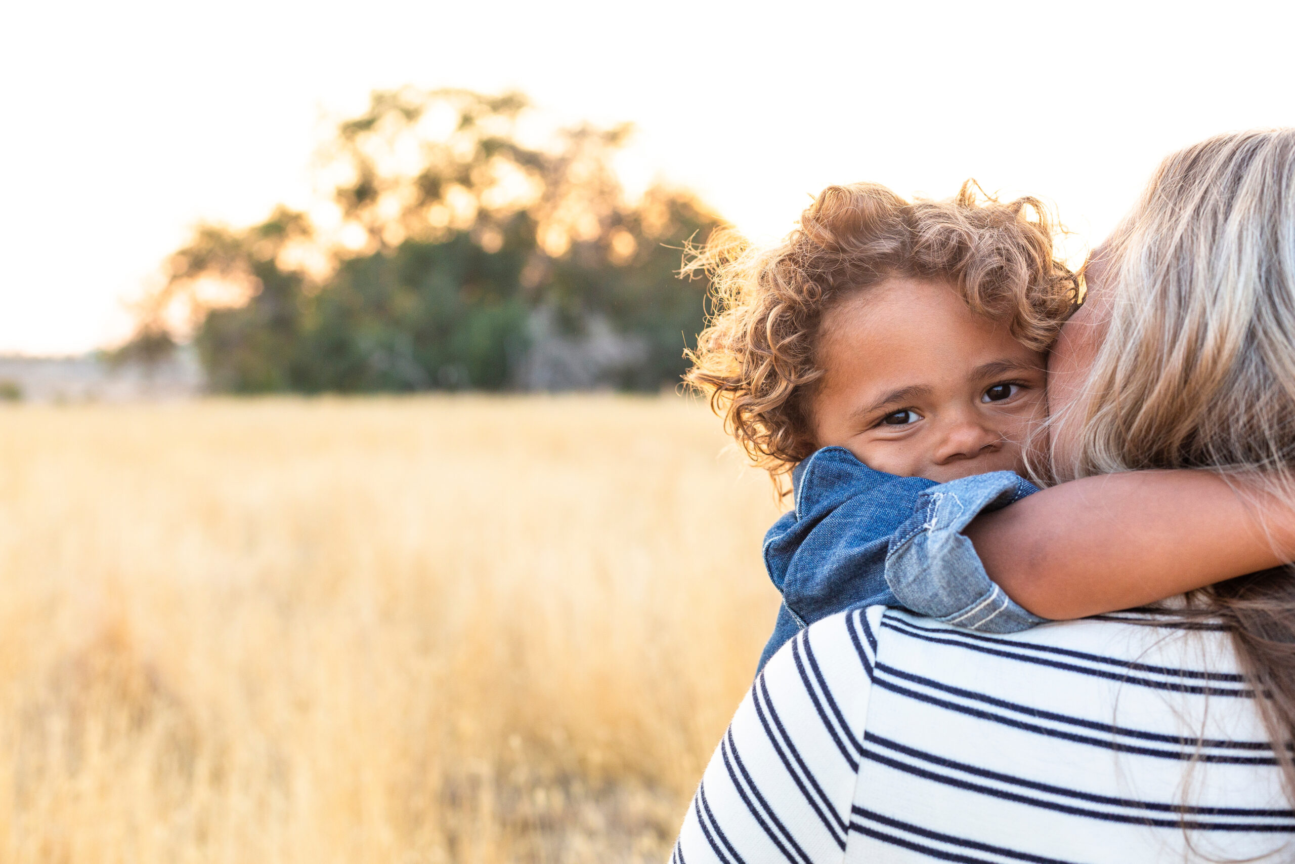 A smiling child in his mother's arms [Veritus Client Corner: Former Optometrist Now Helps Donors See How They Can Make a Difference for Children]