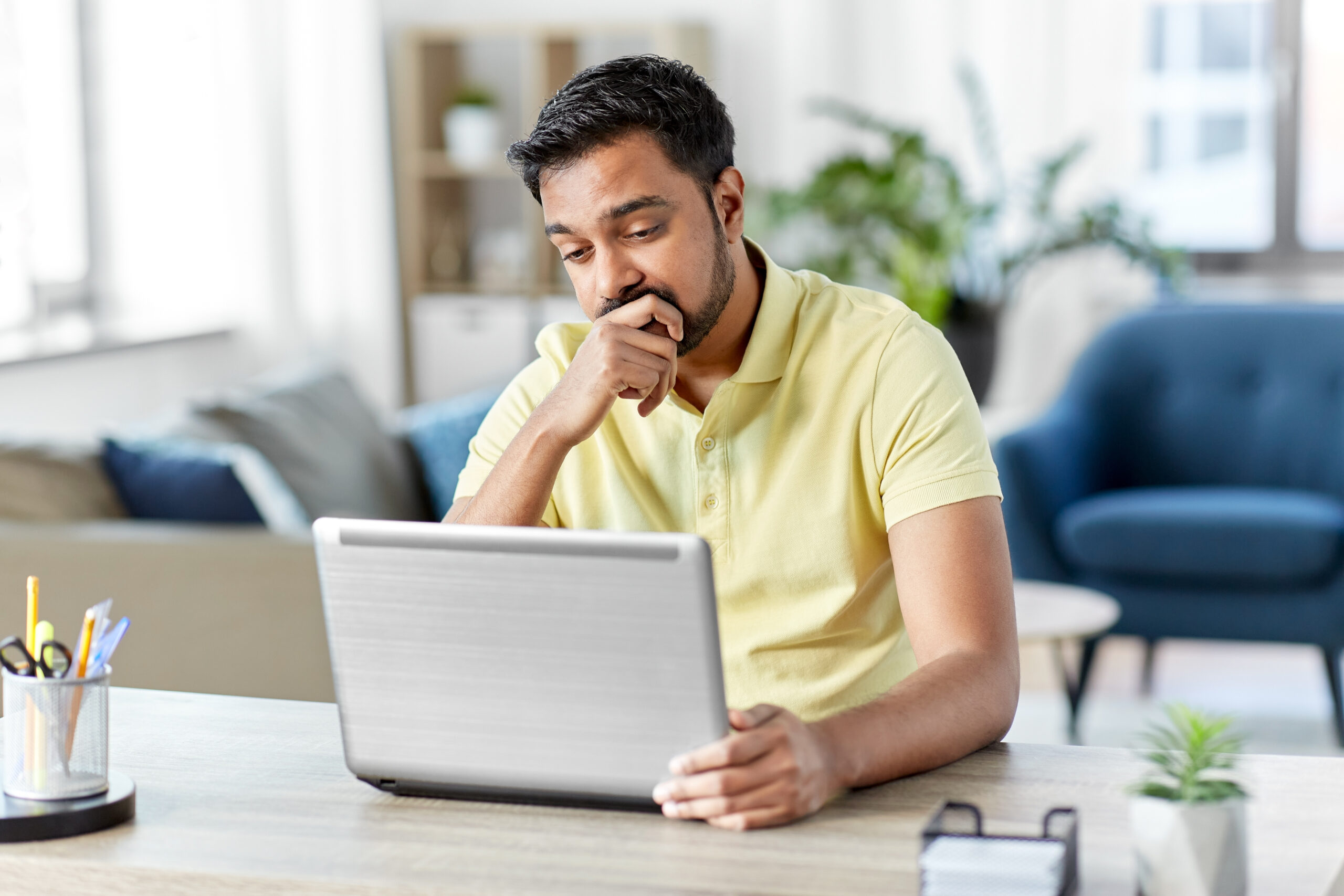 Frontline fundraiser stares nervously at laptop. [Why Asking Boldly Hardly Ever Happens]