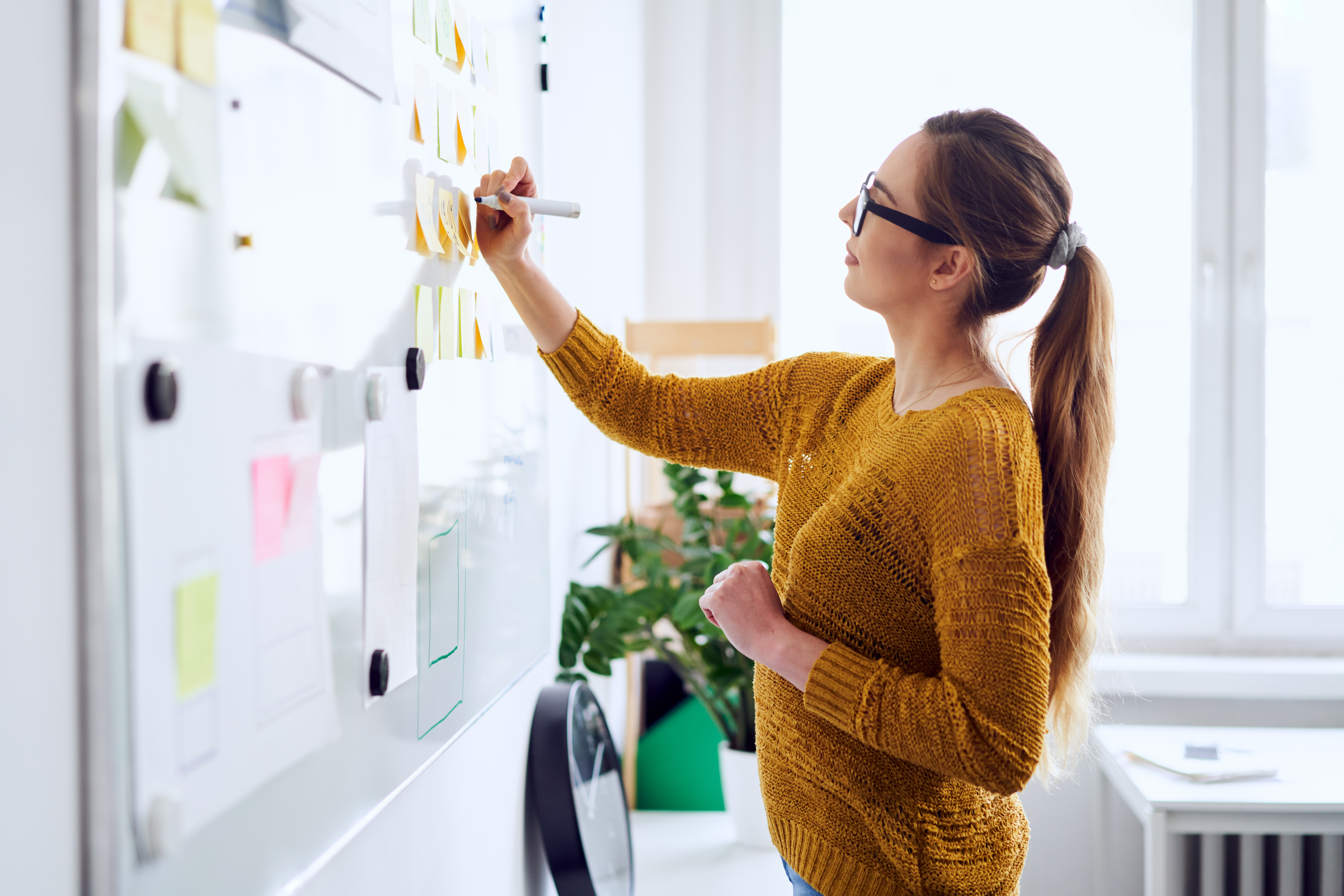 A fundraiser creating her strategic plan on a white board [Do You Have a “December Plan” for Your Major Donors?]