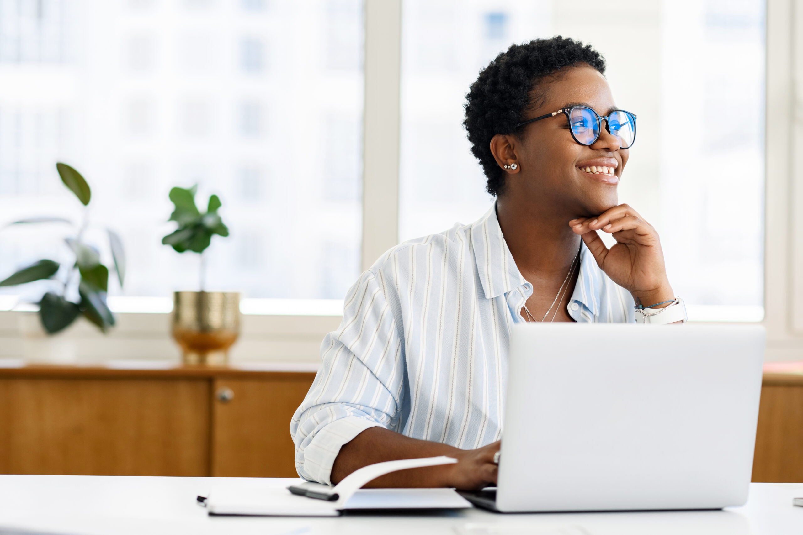 Black female fundraiser in glasses looking away with a light smile.[Embrace Abundance: Free Yourself From the Fear of Not Having Enough]