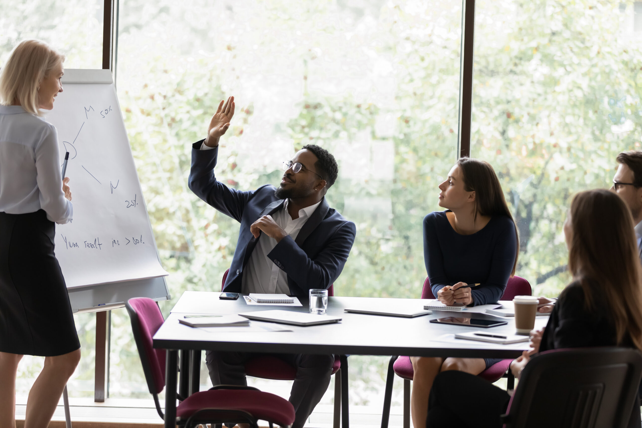 A man raising his hand to ask a question [Beyond the Numbers: Asking the Right Questions in Fundraising]